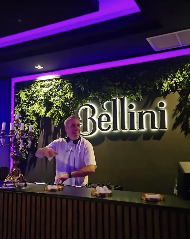 Emilio DJ Ponte como residente en Bellini Rooftop A Coruña con el letrero iluminado al fondo